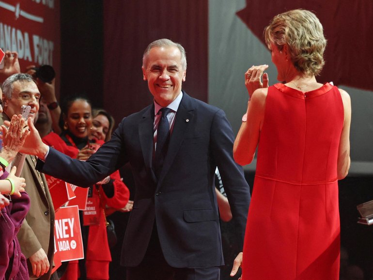Canada's Prime Minister and Liberal Party leader Mark Carney and his wife Diana Fox Carney greet supporters at a victory party in Ottawa.